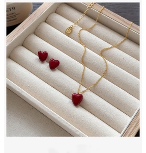 Detail of S925 sterling silver jewelry set with red heart zircon in beige velvet box