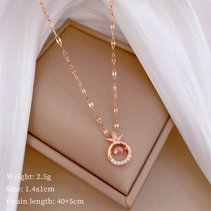 Rose gold dancing stone necklace with bow detail and specifications in a jewelry box
