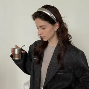 Silver metallic PU leather hairband with y2k laser finish on a model showing high top volume