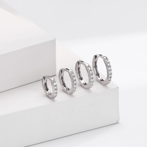 Detail of four S925 sterling silver hoop earrings with sparkling cubic zirconia inlay