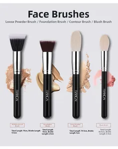 Flat lay of four makeup brushes including foundation and powder brush with soft bristles