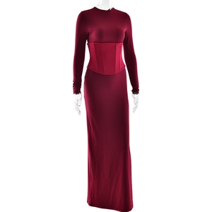 Close-up of elegant deep red long-sleeved maxi dress with slim fit waist and high-quality texture