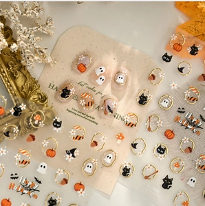 Detail of 3D Halloween nail stickers with embossed gold pumpkin and ghost patterns