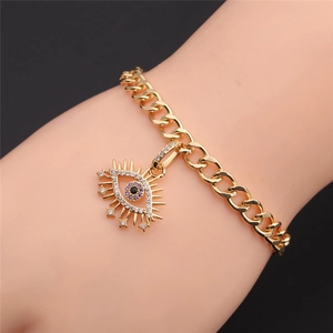 Detail of gold-plated evil eye bracelet with purple and white zircon crystals on model