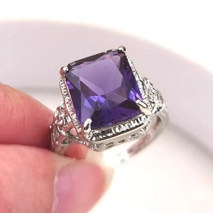 Vintage silver ring with a large rectangular purple amethyst and intricate engraved patterns