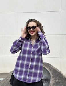 Detail of classic purple plaid flannel shirt with front pocket and button-down collar