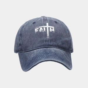 Detail view of washed denim baseball cap with white FAITH embroidery and cross symbol