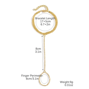 Three-layer gold bow finger bracelet with turquoise beads and pearls on white background