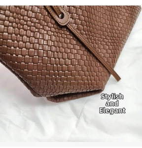 Dettaglio della borsa tote in pelle intrecciata marrone con trama fitta e tracolla chic