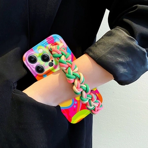 Graffiti iPhone case with pink green braided strap worn by model in black blazer