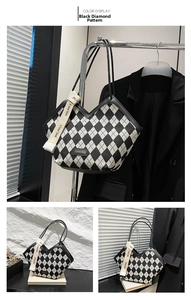 Detailed view of black and white argyle tote bag with leather straps and logo plaque