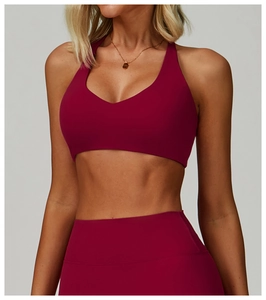 Detailed view of dark red sports bra and high-waist leggings with matte brushed texture