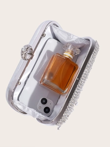 Silver rhinestone evening clutch with tassel showing interior space for phone and perfume