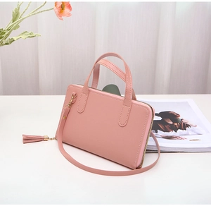 Detail view of pink PU leather handbag with elegant tassel and detachable shoulder strap