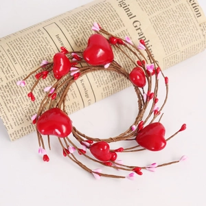 Detail of a red heart wreath with decorative berries and rustic branch texture