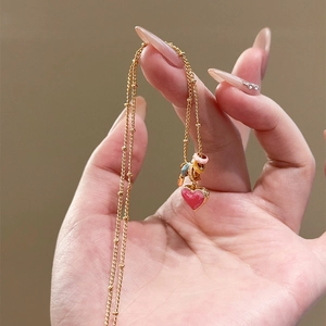 Gold-plated ball chain necklace with pink heart pendant and colorful enamel rings