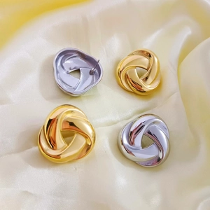 Exaggerated geometric twisted triangle stud earrings in polished gold and silver finish