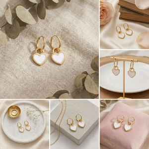 Detail showing the white enamel heart charm on a golden stainless steel hoop earring