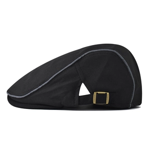 Detail of adjustable metal buckle and contrast grey piping on black cotton flat cap