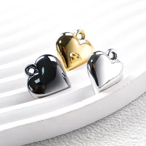 Metallic heart pendants in gold, silver and gunblack finishes on white display