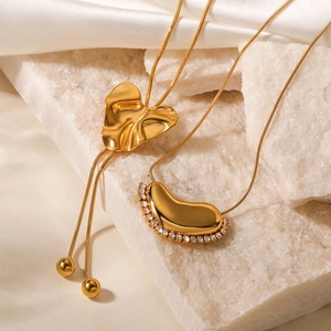 18K gold plated heart and bean pendant necklaces on silk background for women