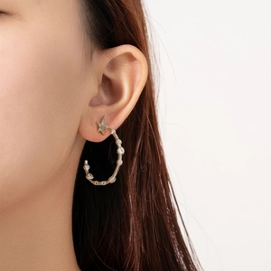 Close-up of S925 silver star hoop earrings with sparkling white zircons on a model