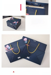 Detail of floral gift bag showing reinforced golden rope handles and sturdy base