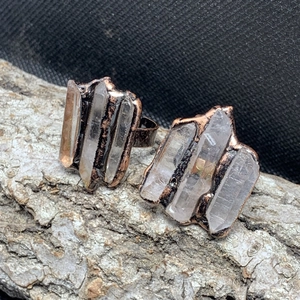 Vintage copper open ring featuring three raw white crystal points on natural wood