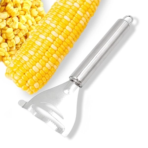 Macro shot of stainless steel corn peeler with fresh kernels on a clean white background