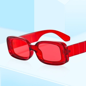 Fashionable red square frame sunglasses with transparent finish on light blue platform