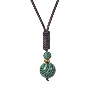 Détail du collier en perles de malachite verte avec cordon tressé et intercalaire doré