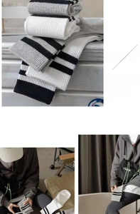 Close-up of ribbed cotton mid-calf socks with grey, white and black striped details