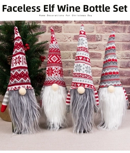 Close-up of four knitted Christmas gnome wine bottle covers with snowflakes and beards