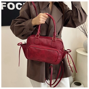 Close-up of vintage dark red PU leather handbag with zipper pocket and drawstrings