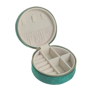 Interior view of a round dark green velvet jewelry travel case with ring slots and hooks