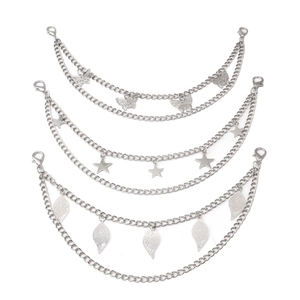 Close-up of silver metal multi-layer bag chains with butterfly, star and leaf charms