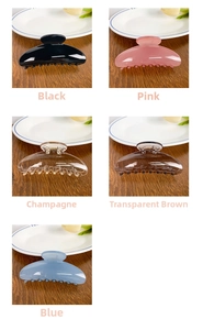 Detail shot of elegant semi-circular hair claws in black, pink, blue and champagne colors