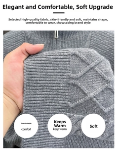 Detail eines grauen Zopfstrickpullovers mit dickem Rippbündchen und Metallreißverschluss