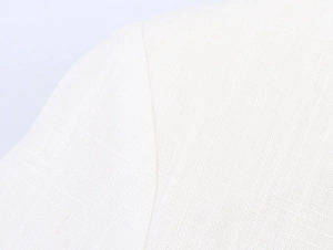 Detailed macro view of white linen-like woven fabric texture and stitching on the coat