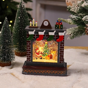 Detailed view of a Christmas fireplace music box with Santa and glowing water globe