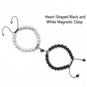 Close-up of heart-shaped magnetic buckle connecting black and white marble bead bracelets