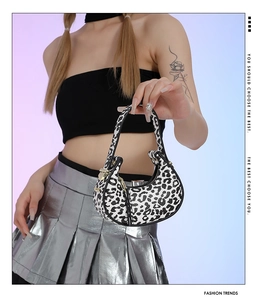 Fashionable leopard print underarm bag shown with metal zipper and Y2K styling details