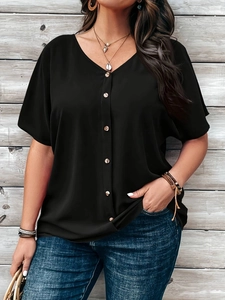 Close-up of black V-neck short sleeve buttoned shirt styled with denim jeans for women