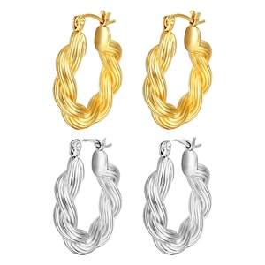 Detailed view of twisted rope hoop earrings in polished gold and silver plated finishes