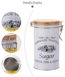 Detail of white metal sugar canister featuring a wooden lid, steel buckle, and farm motif