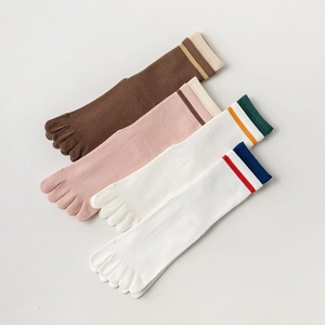 Set of four pairs of breathable cotton yoga toe socks in brown, pink, and white stripes
