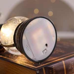 Detail view of the Christmas lantern base showing the battery compartment and speaker