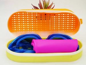Close-up of silicone protective case with blue swim goggles and pink accessory
