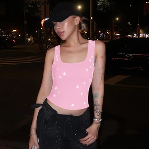 Detail of pink cropped tank top featuring white water-drop sequins in a street style look