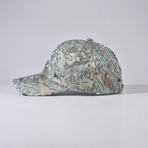 Oriental style baseball cap with silver brocade and traditional wave patterns in 45-degree view
